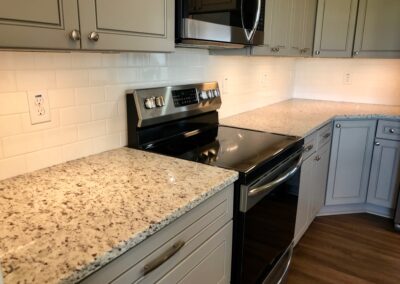 Kitchen with white subway tile and White G granite